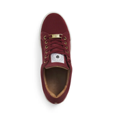 Maroon trainer with gold laces on a white background